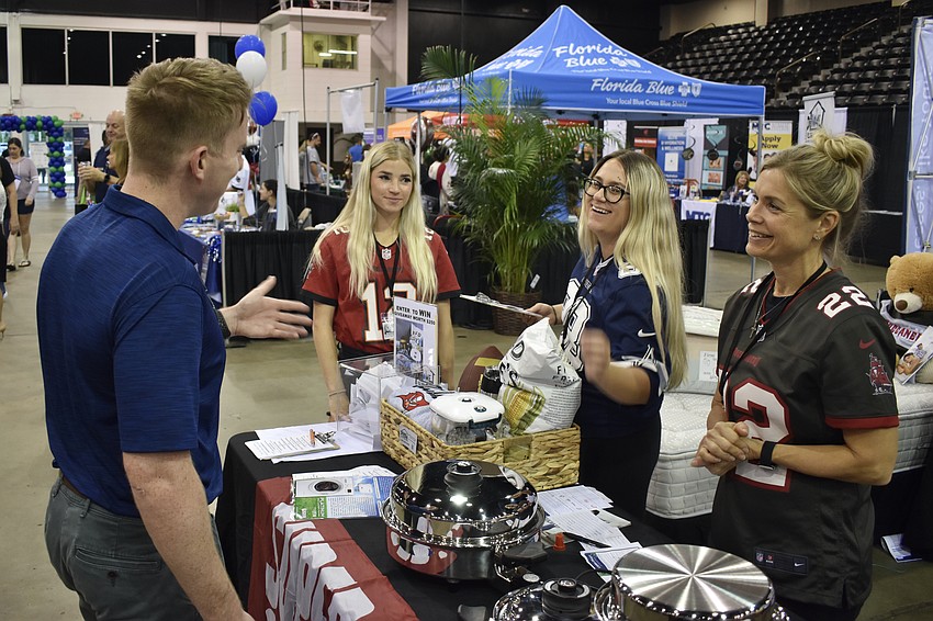 Sarasota's Brendan Ward speaks with Sarasota's Corrie Moore and Brittany Bontell and Lakewood Ranch's Heather Terwilliger of Pure Home 365.
