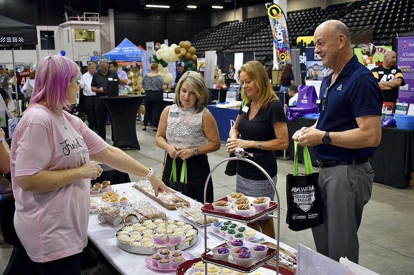 Alicia Carden of Frosted Pink showcases treats to Lakewood Ranch's Cherri Kessler, Terri West and Bradenton's Bob MacDonald.