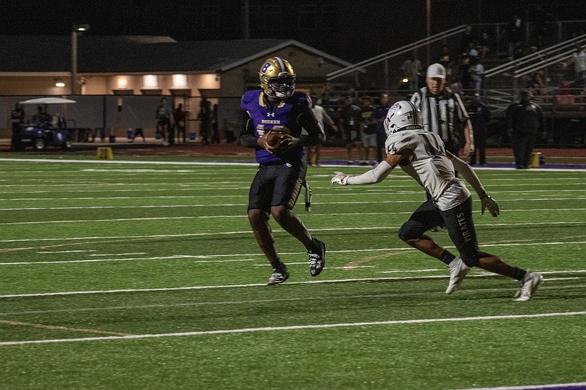 Booker High junior quarterback Jordan Johnson buys time with his legs. Johnson would find senior receiver Joshua Burrows for a touchdown.