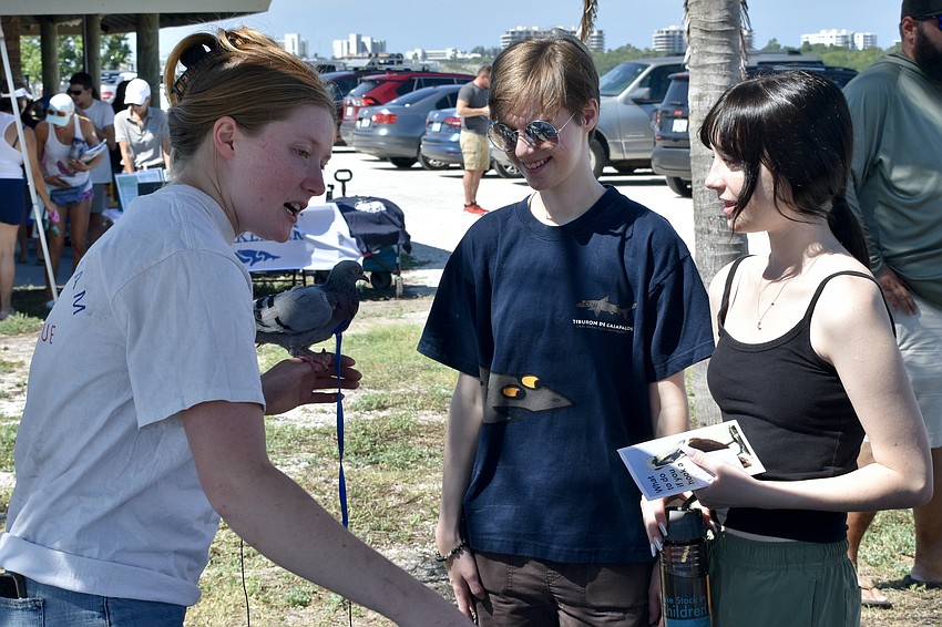 Charlotte Arndt of Arndt Animal Center for Rehabilitation and Environmental Education (AACREE) speaks with Jamie Taylor, 17, and Charlotte Taylor, 16.
