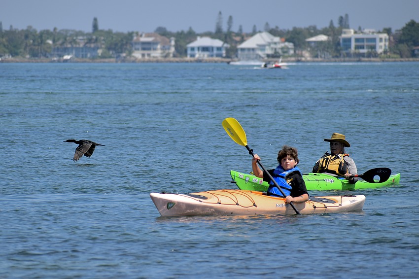 Slayter Bigelow, 9, takes his first-ever kayaking trip alongside Wayne Adventures owner Wayne Douchkoff.