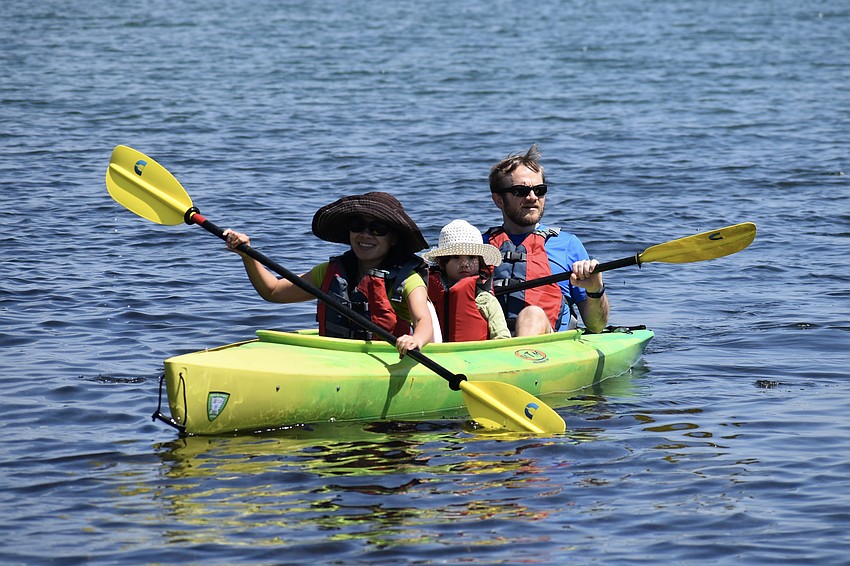 Hang Reusch, Lily Reusch, 5, and Justin Reusch enjoy a kayaking trip together.