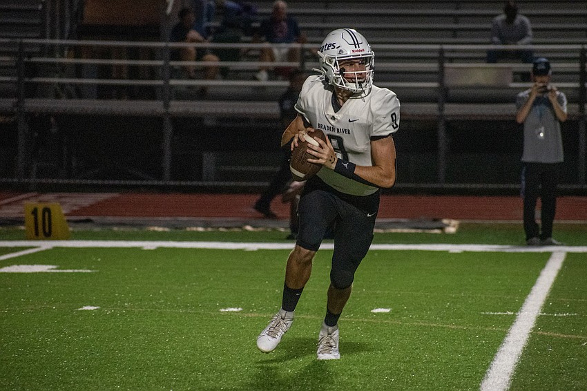 Braden River junior quarterback Lucas Despot rolls to his right to find a receiver.