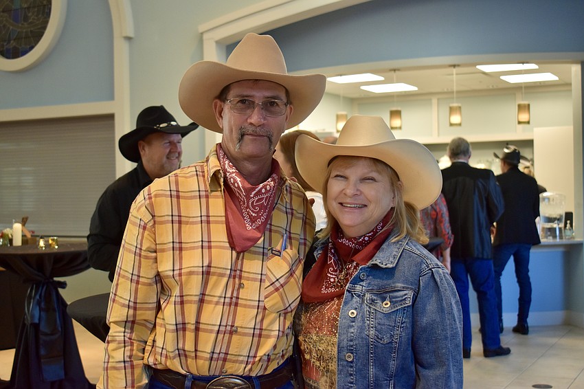 Real life Arcadia cowboy Allen McClelland is accompanied by Wendy Hunter. Hunter's employer, Fish Branch Tree Farm, bought a table for its employees.