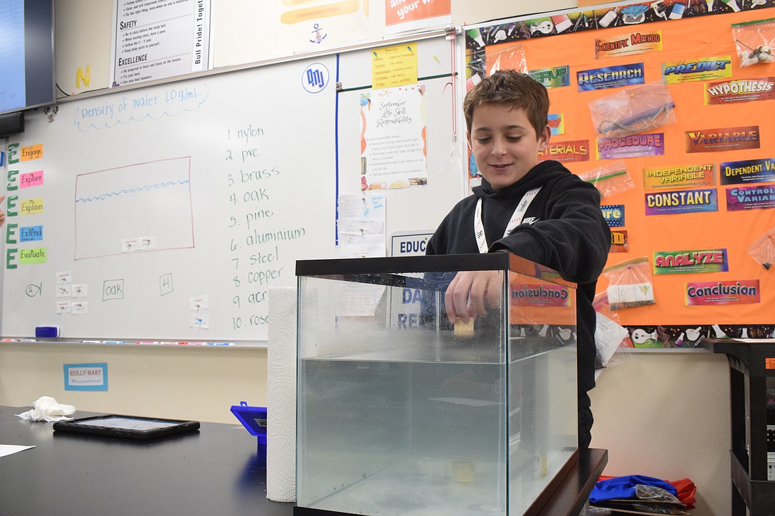 Dr. Mona Jain Middle School eighth grader Anthony Mundo participates in a hands-on Woz Ed lesson on density.