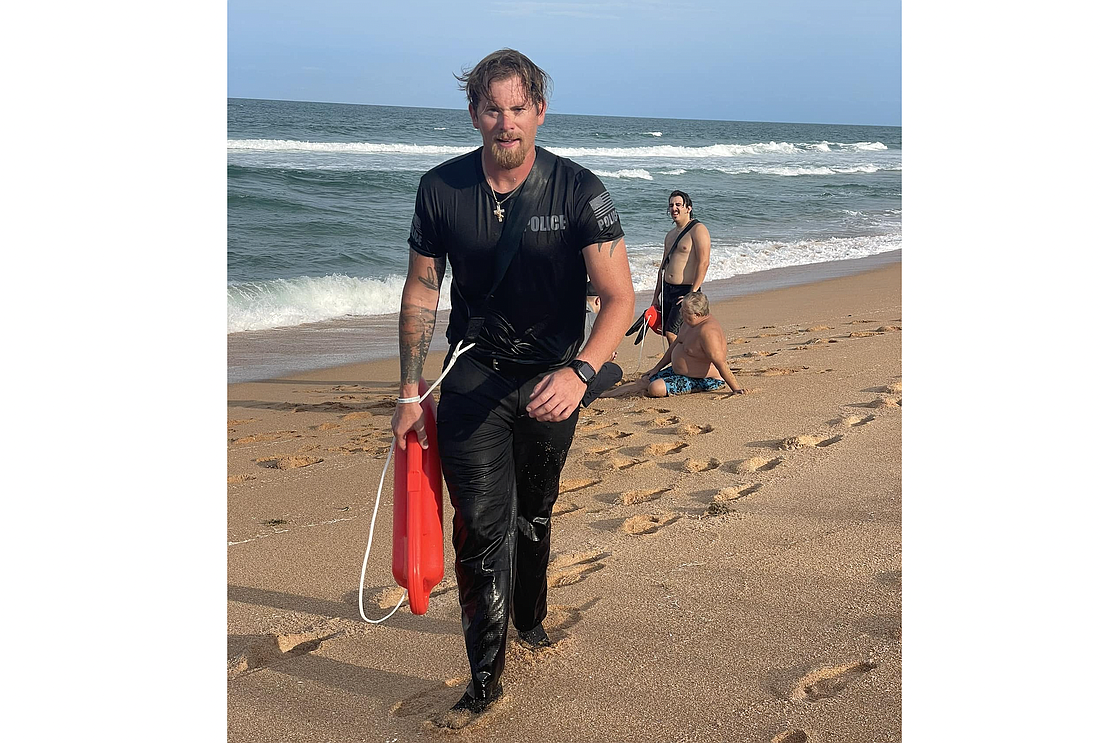 Flagler Beach Police Officer Dylan Coffman jumped over the boardwalk railing to help two swimmers in distress. Photo courtesy of the FBPD