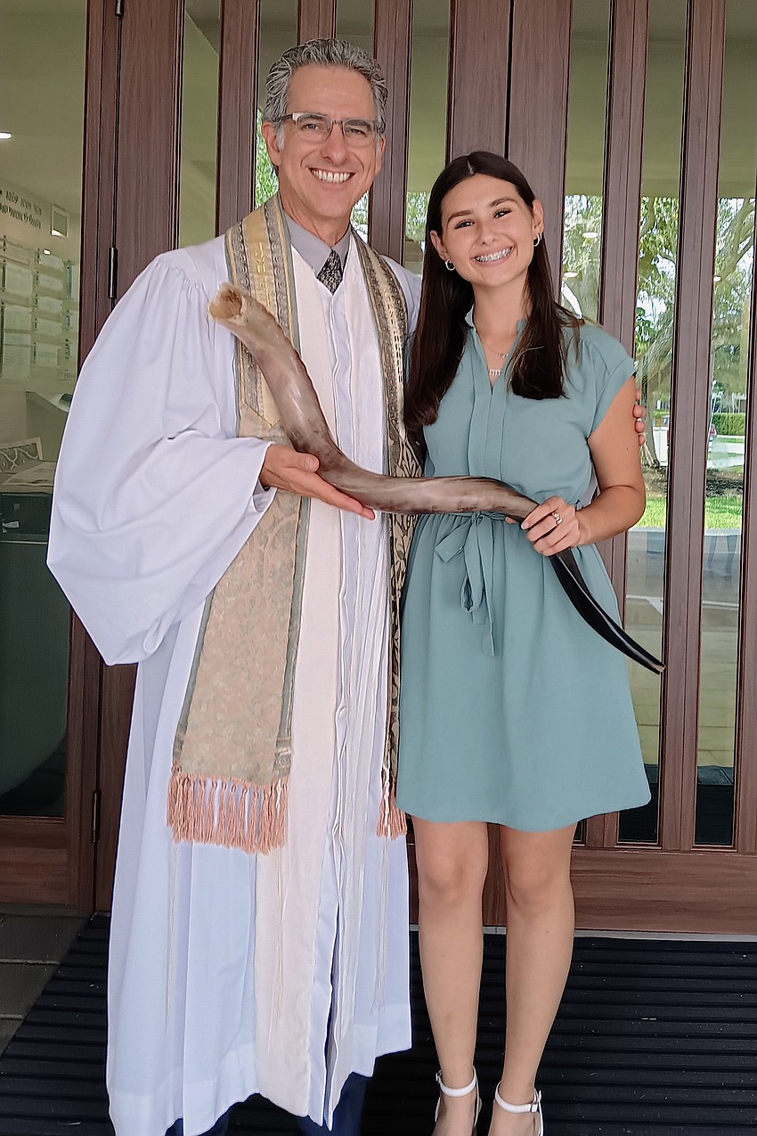 Rabbi Brenner Glickman and Ba'alat Shofar Maxine Mintz, a member of Temple Emanu-El's confirmation class. The Ba'alat Shofar is the individual who blows the shofar, a musical horn.