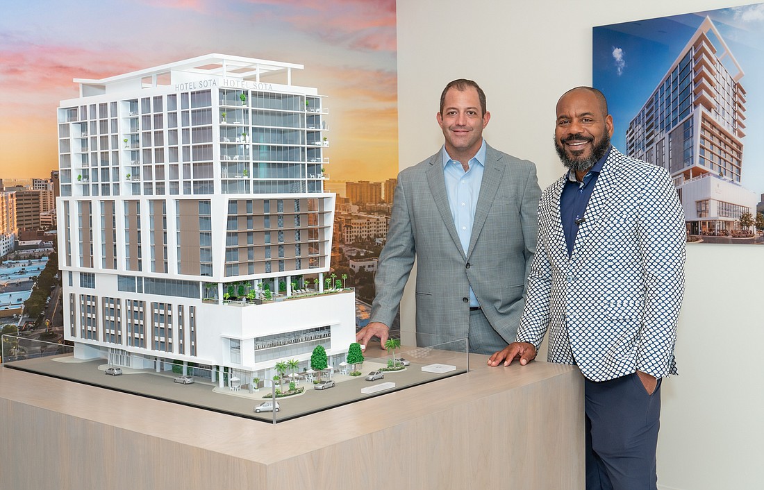 Developer Rodrigo Trepp (left) and financial partner Micheal Ealy with the scale model of SOTA.