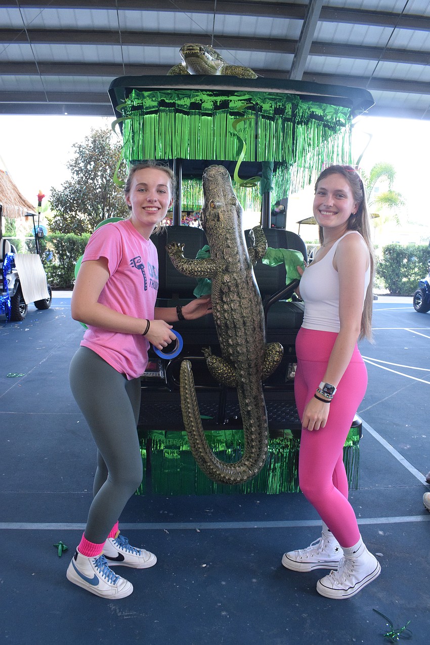 Seniors Ava Banks and Devon Van Hoesen continue to add decorations to their golf cart.