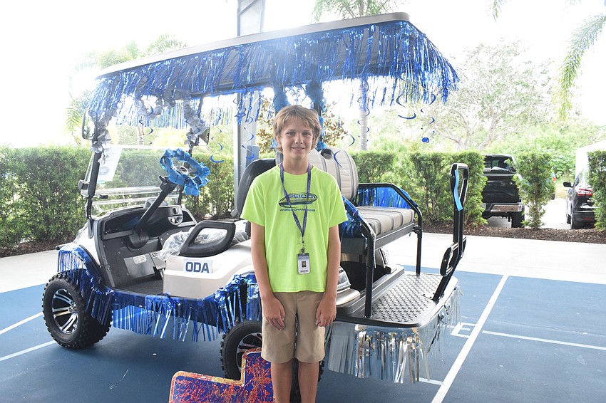 Seventh grader Grant Campbell says it's fun to decorate the golf cart and represent his grade.