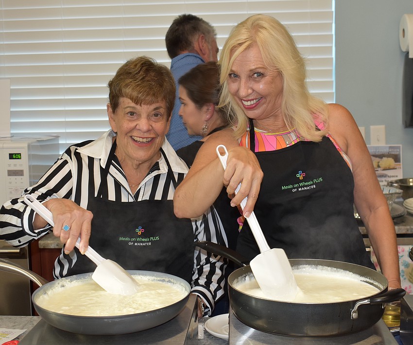 Harrietta Krasnoff and Wanda Martinetto stir, stir, stir the Alfredo sauce.