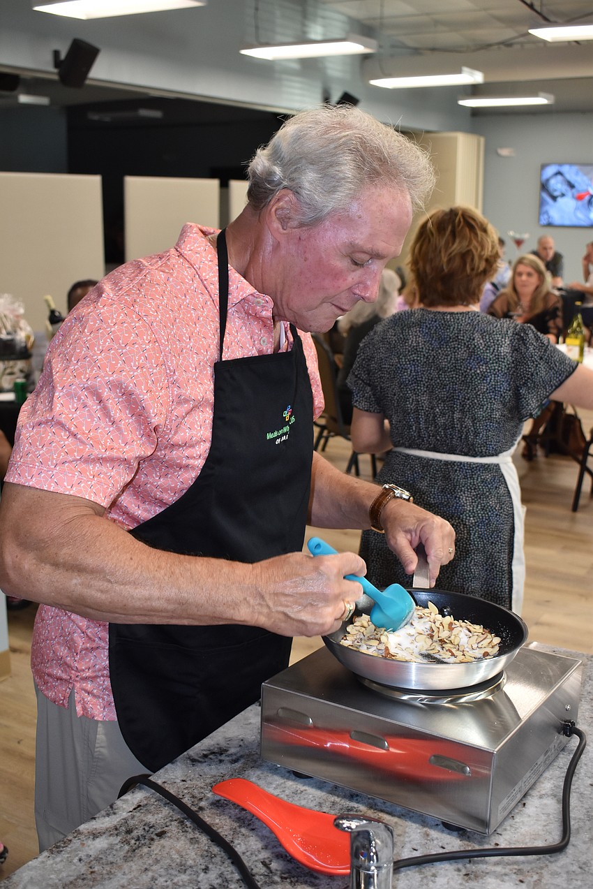 Ed Martinetto stirs the candied, sliced almonds that served as a terrific appetizer.