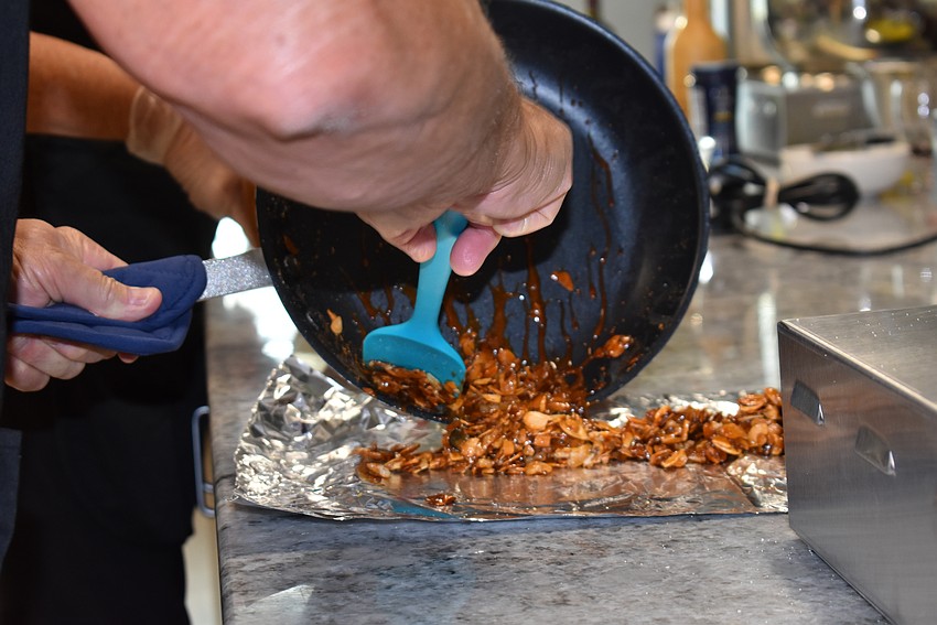 Ed Martinetto scoops out the candied, sliced almonds.