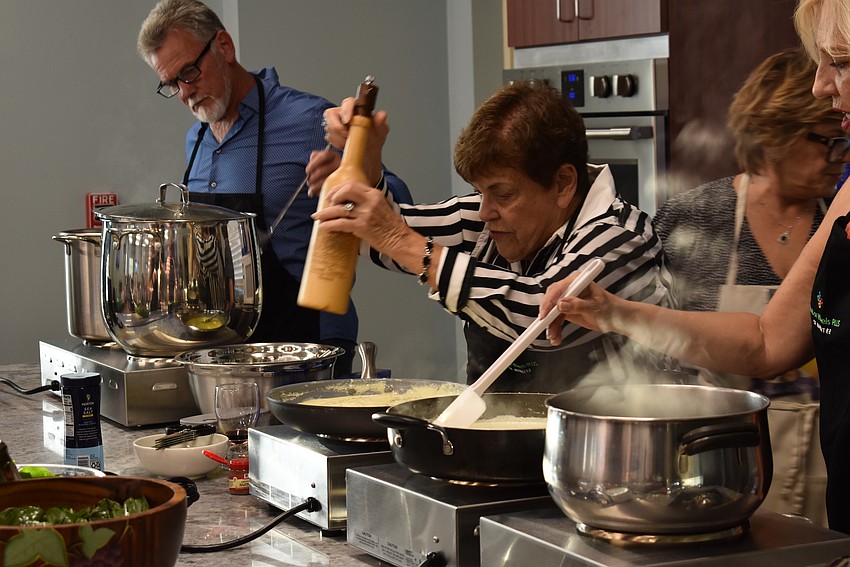Harrietta Krasnoff adds the pepper to the Alfredo sauce.