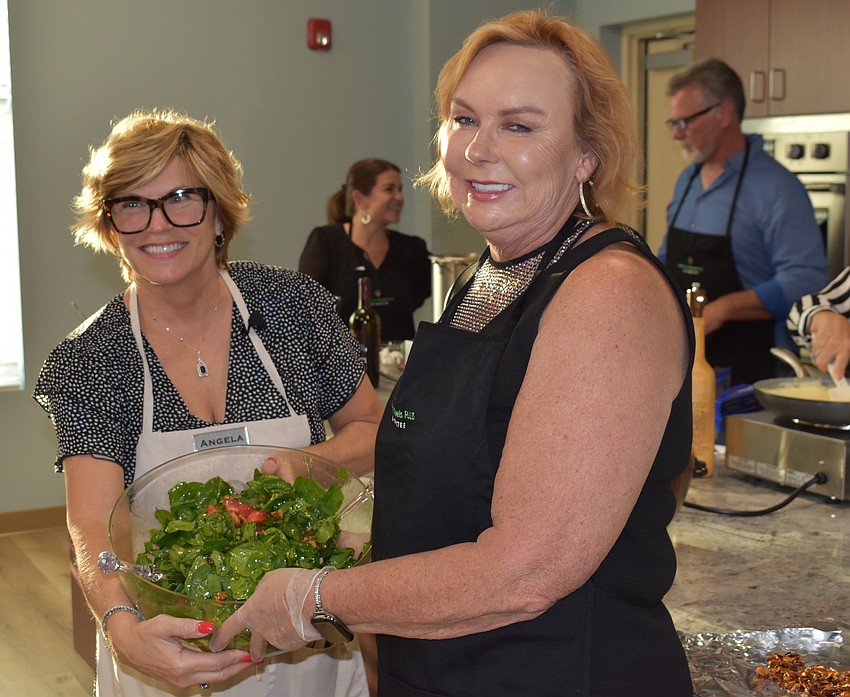 Angela Massaro-Fain and Pamela Modisett show off a spinach salad.
