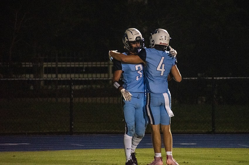 ODA receivers John Moschella and Jack Meyers hug after Meyers' touchdown catch against Santa Fe Catholic.