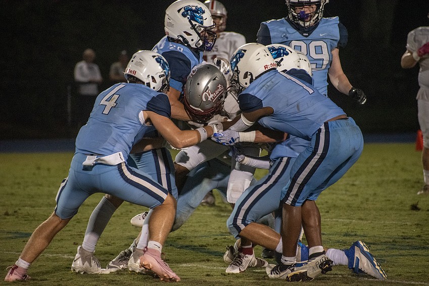 A swarm of ODA tacklers, including Jack Meyers (4), take down a Santa Fe ball carrier.