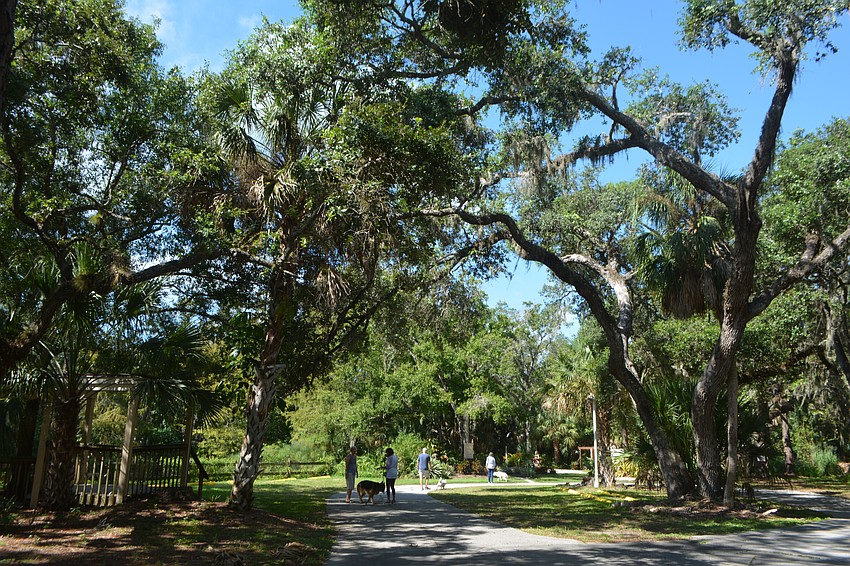 Dogs and their owners explore the grounds at Unity of Sarasota.