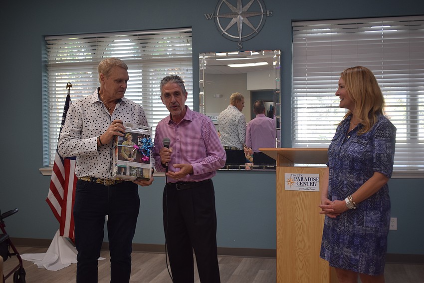 Chris Sachs and Micahel Garey presenting the suprise service award to Emily Walsh.