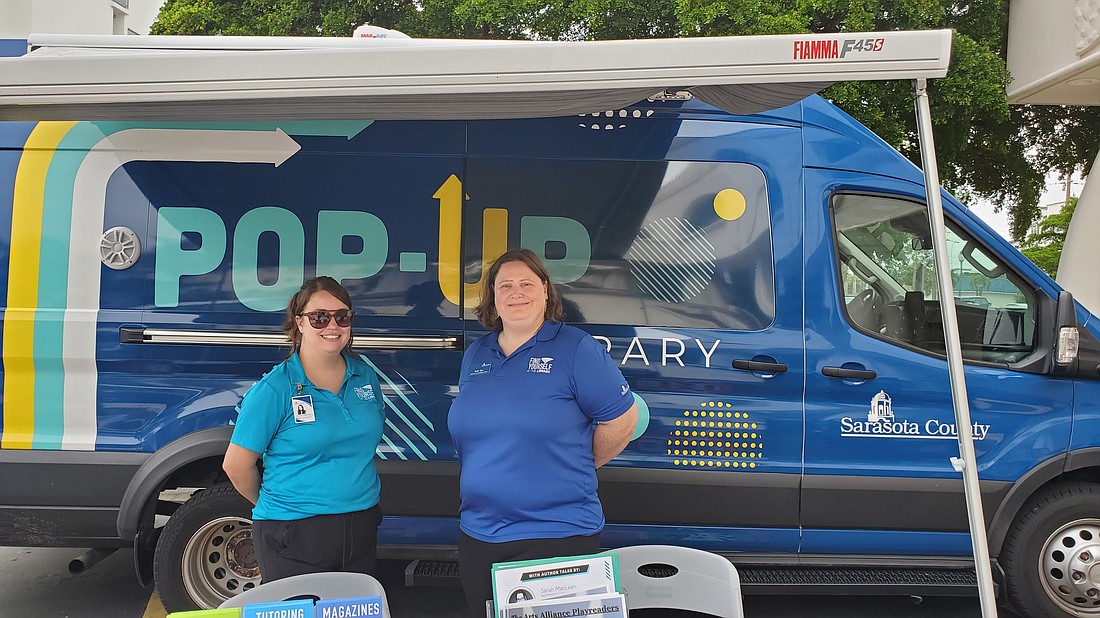 Alyssa Rockey, outreach services supervisor, and Katie Dow, manager of programs and partnerships in front of the Pop-Up Library
