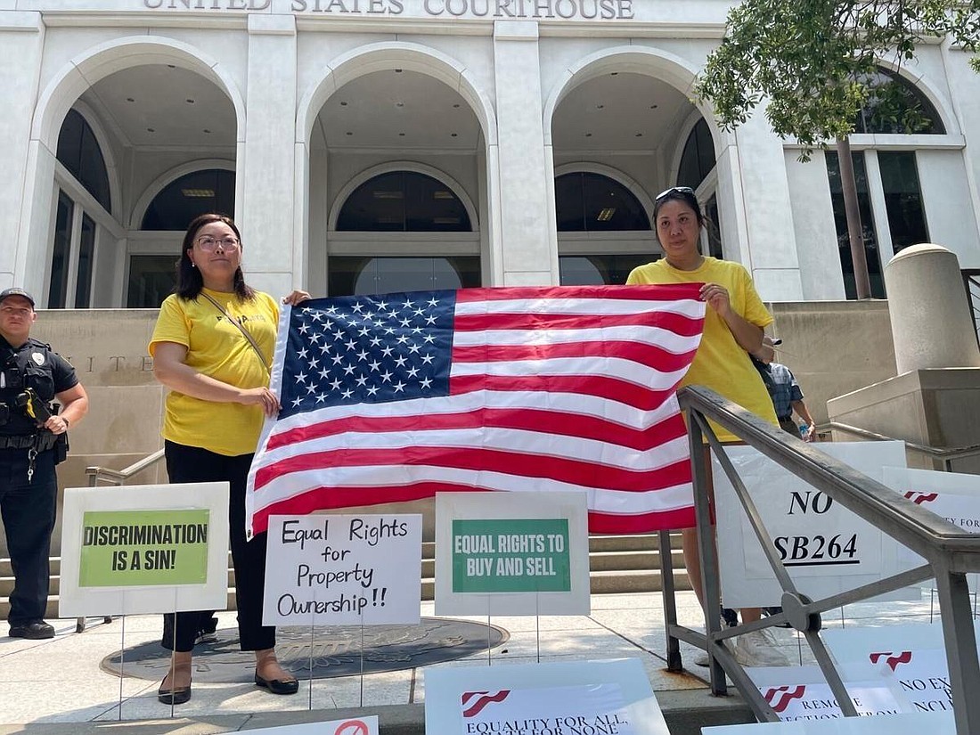 Protesters gathered this summer outside the federal courthouse in Tallahassee to oppose a law that placed restrictions on people from China buying property in the state. File photo by Tom Urban/The News Service of Florida