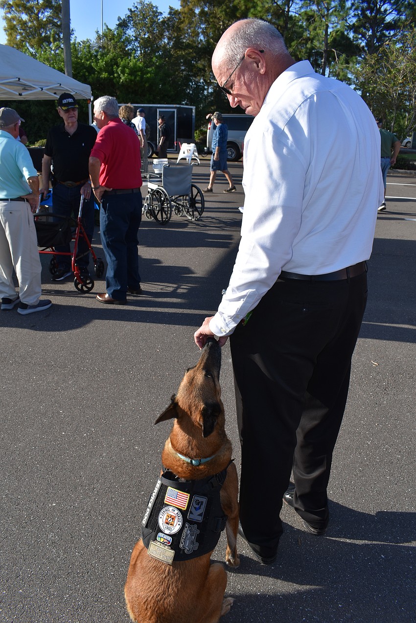 Canines for Heroes founder Mark LaFlamme bought 12-year-old service dog Allie to the ceremony. To learn more about the organization, go to CaninesForHeroes.org.