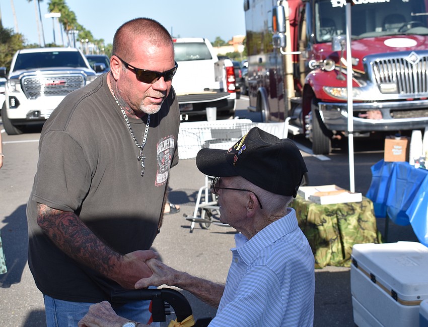Bradenton's George Frabotta visits with 105-year-old World War II veteran John Skeen before the ceremony.