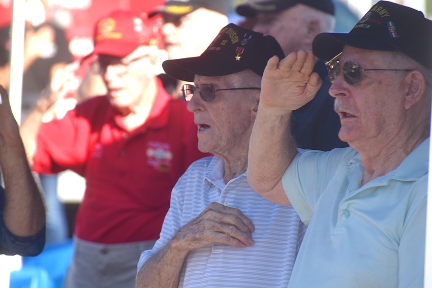 East County's John Skeen and Bob Pence sing the National Anthem during a World War II flag raising reenactment Oct. 5 in the Lowe's parking lot in Creekwood Crossing.
