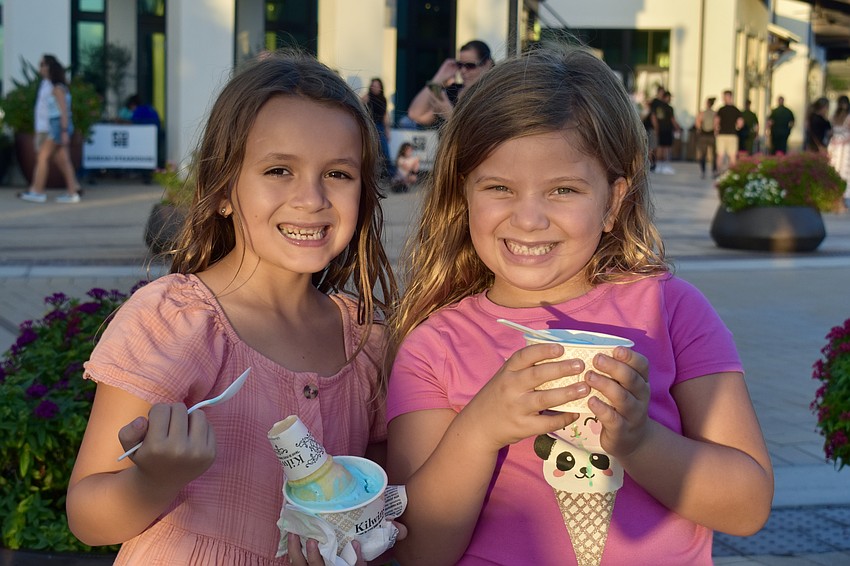 Layla Lamoreux, 7, and Olivia Burton, 5, enjoy an interesting two-scoop ice cream combo of mint chocolate chip and cotton candy.