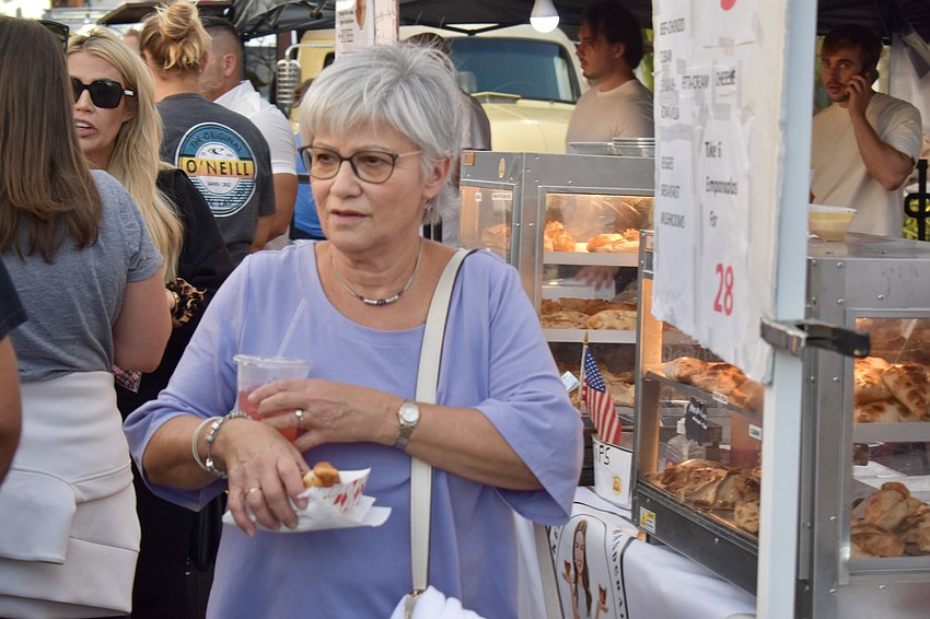 Lakewood Ranch resident Beth Edelstein grabs a spicy beef empanada for her husband.