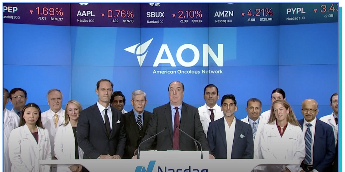 American Oncology Network CEO Todd Schonherz, center, helped ring the opening bell for the Nasdaq exchange Sept. 21.