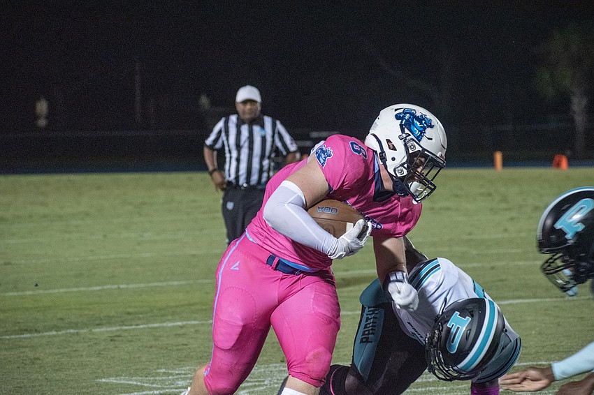 ODA senior running back/linebacker Charlie Tack lowers his shoulder into the Bell Creek defense.