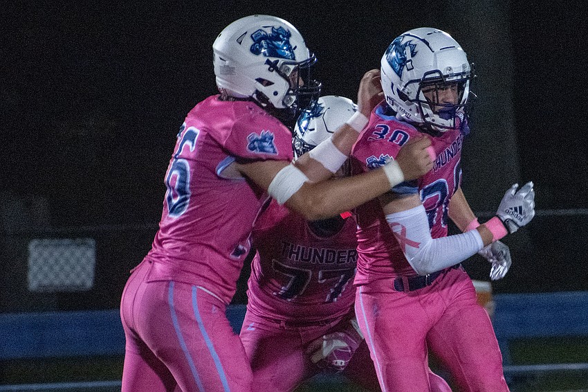 ODA freshman linebacker/safety Devin Erdei (30) celebrates an interception against Bell Creek with freshman defensive end Trevor Kovatch (56).