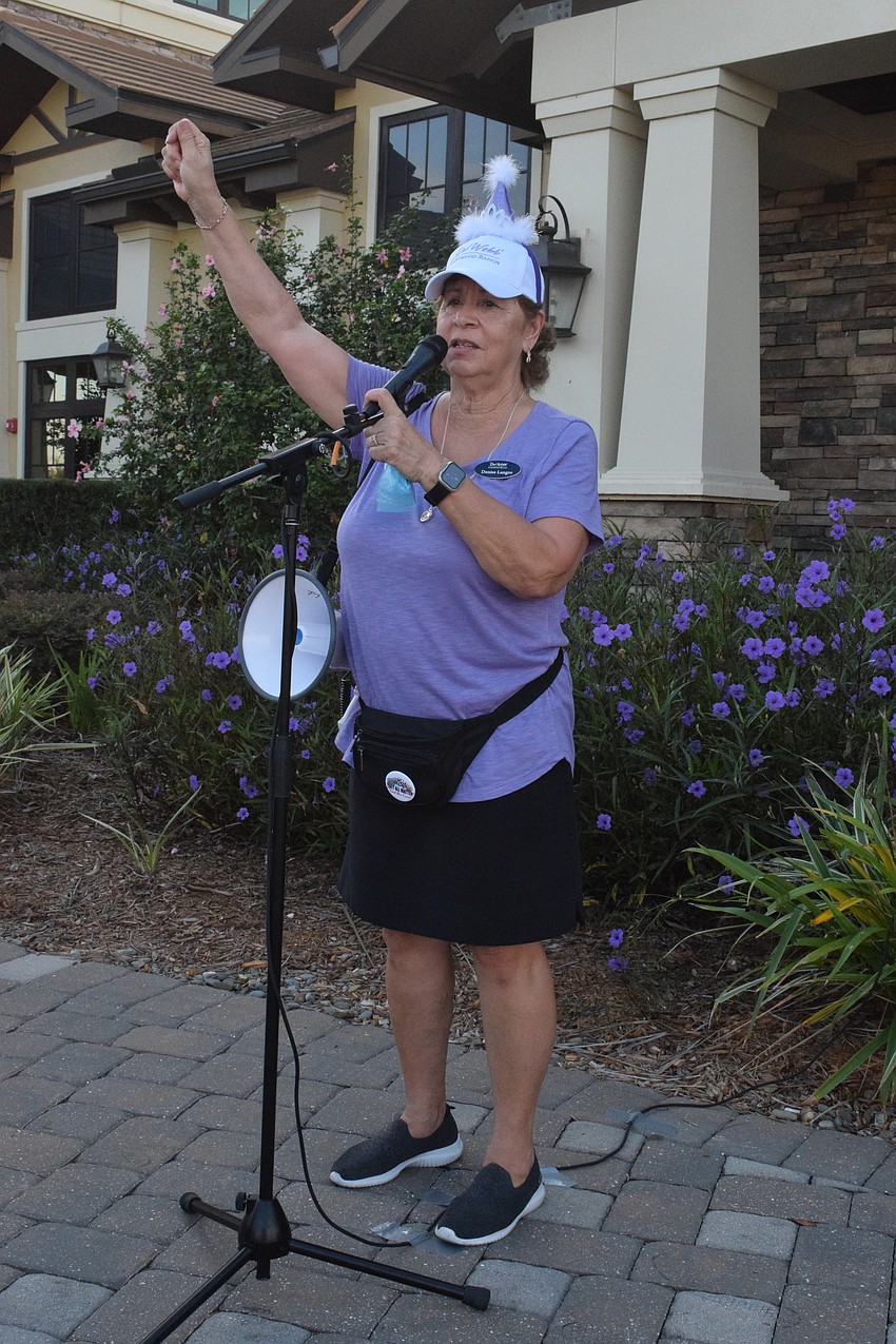 Del Webb's Denise Langro welcomes participants to the Del Webb Breast Cancer and Beyond Walk. The walk this year is in support all people impacted by all types of cancer.