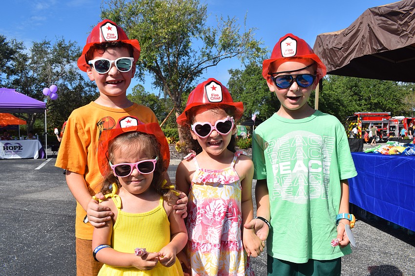 Although Lakewood Ranch 8-year-old Kenny Van Slyck, 3-year-old Carmela Van Slyck, 5-year-old Angelina Van Slyck and 6-year-old Vincent Van Slyck love seeing the first responder vehicles, they also love the free snacks.