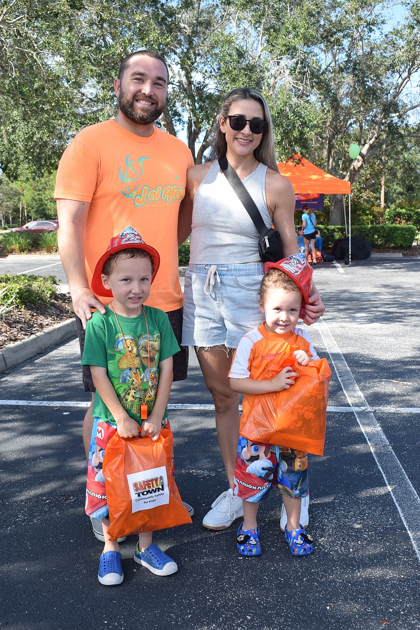 Lakewood Ranch's Bill and Nicole Schorn spend time introducing their sons to the various emergency services and first responders at Safety Town.