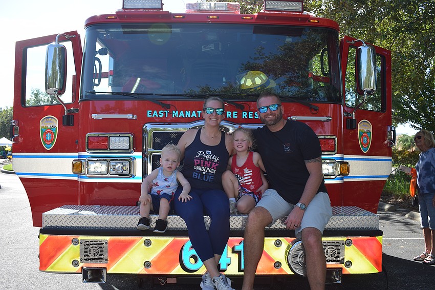 Parrish 2-year-old Zander Vinopal checks out an East Manatee Fire Rescue firetruck with his mother, Meghan Vinopal, 3-year-old sister, Raevin Vinopal, and father, Vinnie Vinpoal.