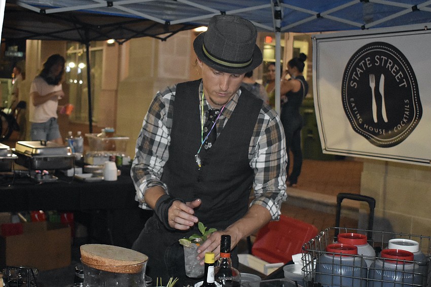 Nicholas Barnhart of State Street Eating House + Cocktails prepares a drink.