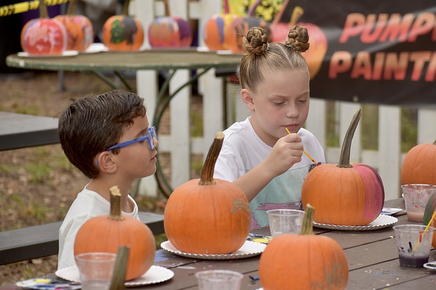 Easton Butcher and Sabrina Funsch participate in pumpkin painting.