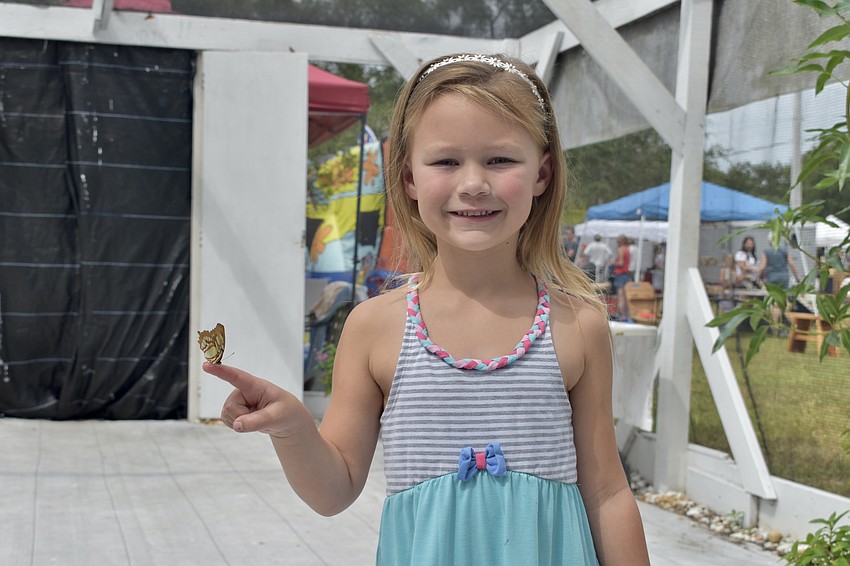 Scarlett Salinger, 5, holds a butterfly.