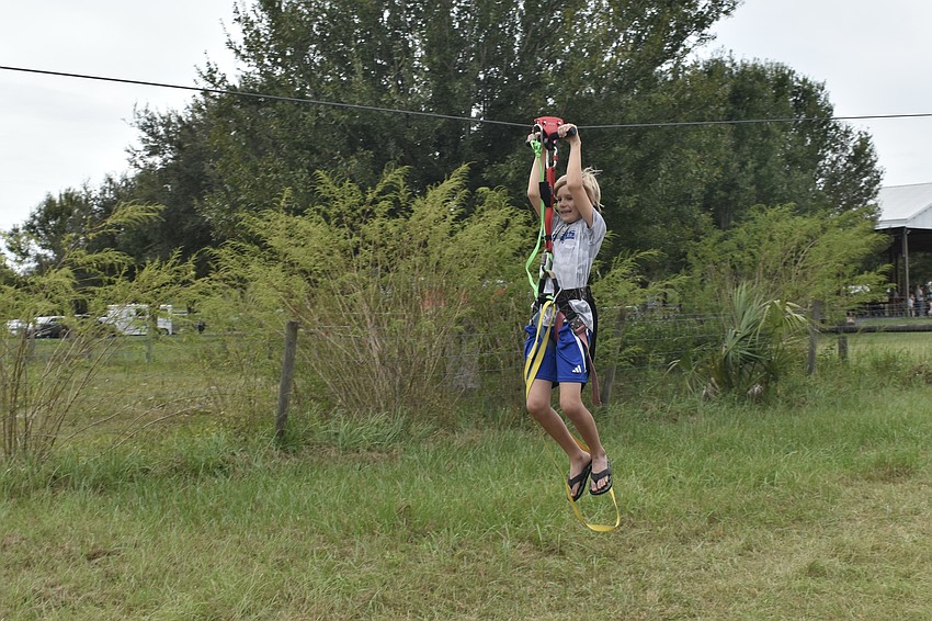 Edward Stoll, 10, tries out the zipline.