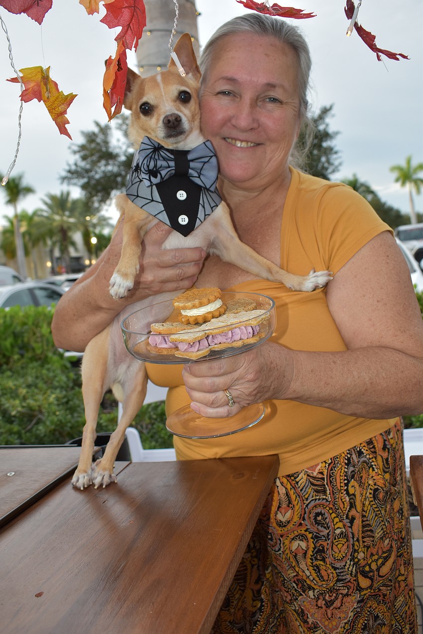Nacho, a 10-year-old Chihuahua, and Julianna Vazquez man their LIT Dog Treats booth at the Barks and Boos event at The Green at UTC.