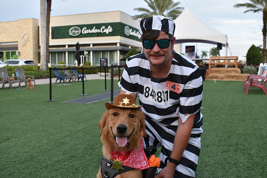 Sarasota's Patrick Schaffer and 7-month-old Gracie play the convict and the sheriff in the Barks and Boos costume contest at The Green in UTC.