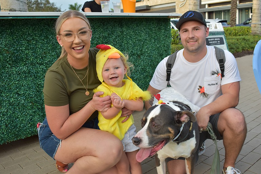 Kaleigh Sulkowski, 2-year-old Amelia Sulkowski, 7-year-old Labrador-mix Tito, and Jake Sulkowski attend Barks and Boos at The Green.