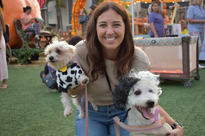 Benderson Development's Julie Fanning scoops up Lulu, a morkie, and Winnie, a pumi, in anticipation of the contest.