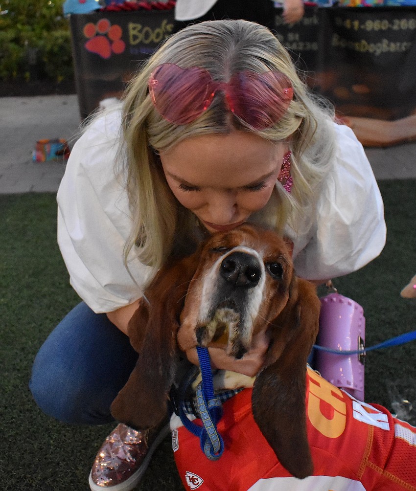 Lakewood Ranch's Amy Hoover, playing Taylor Swift, and 5-year-old basset hound Dooley, playing Kansas City Chiefs tight end Travis Kelce, get ready to walk the Boos and Barks runway for the costume contest.
