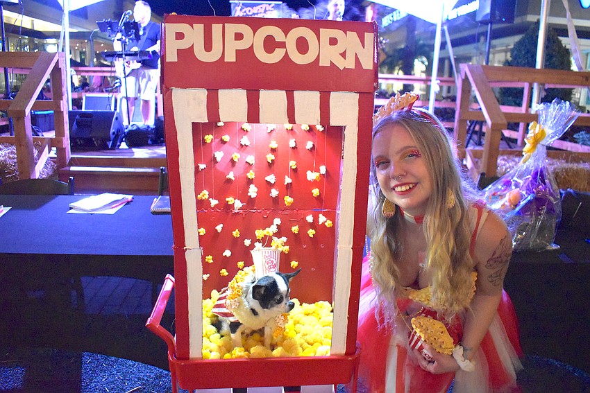 Tampa's Madi Sparks won the Most Creative division of the costume contest at Barks and Boos with 13-year-old Daisy, who seemed to enjoy her perch in a popcorn machine.