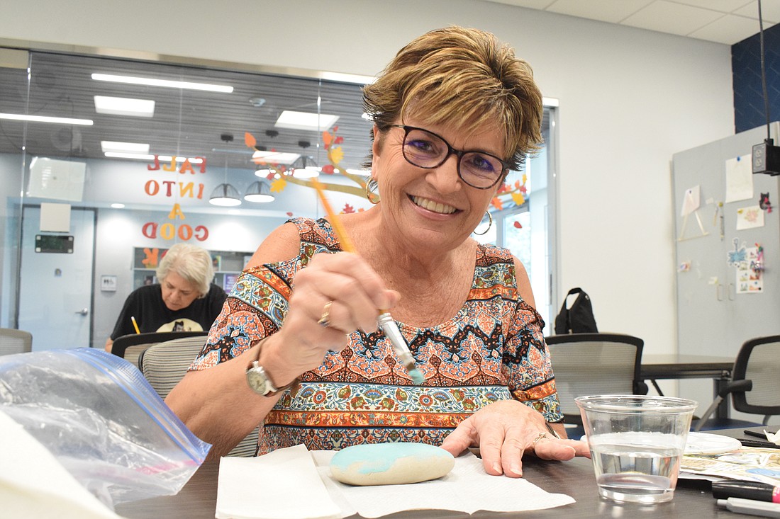 Braden Woods' Kathy Varsalona participates in Braden River Library's rock painting class. She's been painting rocks at home to hide in her neighborhood for the past year.