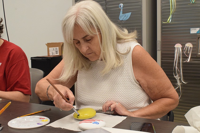East County's Nell Johnston is careful to paint the base coat of her rock.
