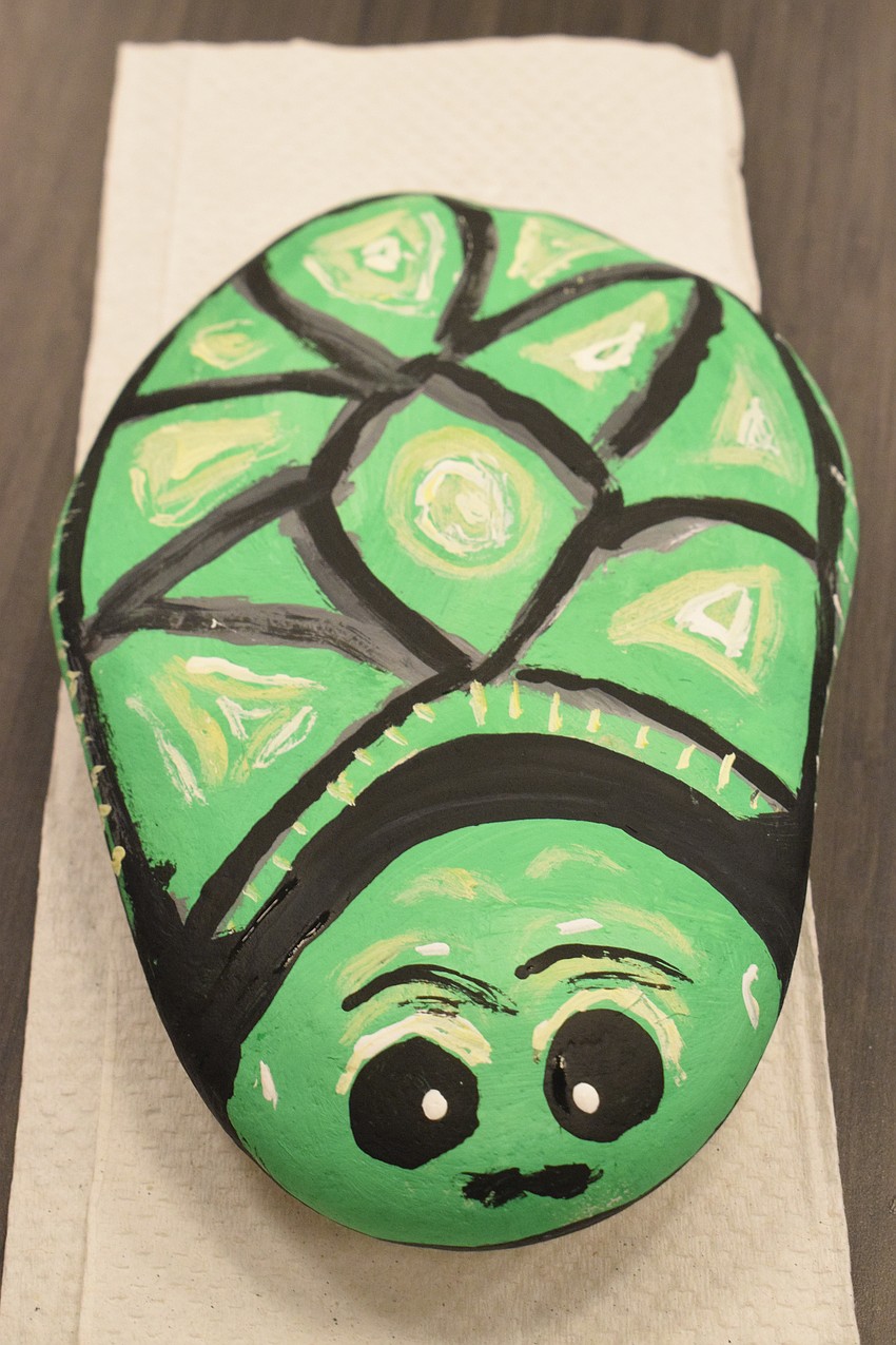 A turtle is painted on a rock that will be put in the butterfly garden at Braden River Library.